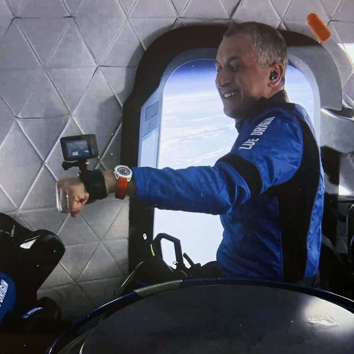 Astronaut Gökhan Erdem shows a Barrelhand Monolith watch in zero gravity during the NS-34 flight